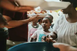 a group of children lined up to be fed